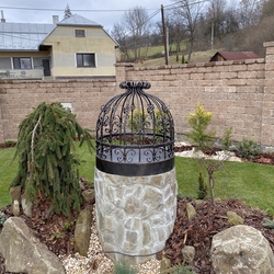 Forged well cover in the garden of a family home near Stropkov