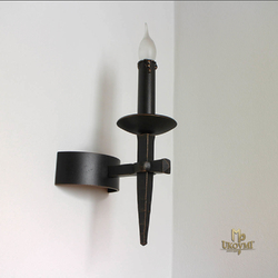 A historical side-wall lighting ‘ANTIK‘ – forged one-candle lamp made in UKOVMI