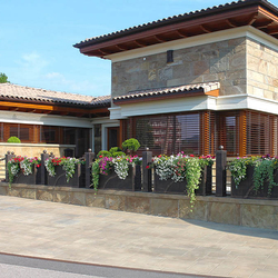 A wrought iron fence with flowerpots