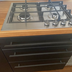 Modern forged handles on kitchen cabinet drawers 