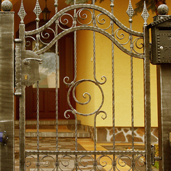 A wrought iron fence - rollmop pattern - An exclusive gate