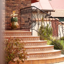 Forged staircase railing at the family house entrance