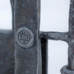 A wrought iron railing with a logo UKOVMI