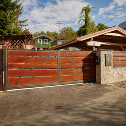 A wrought iron gate - wood - metal, harmony of materials