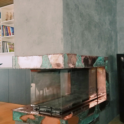 A copper wrought iron fireplace 