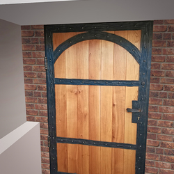 A wrought iron entrance door with wood