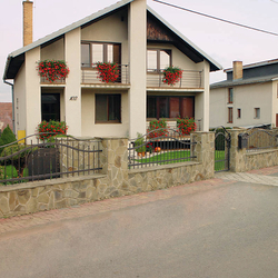 A wrought iron fence and a balcony railing 