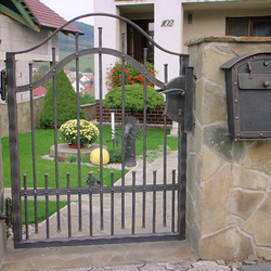 A wrought iron gate and a wrought iron letterbox