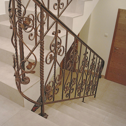 A forged indoor staircase railing into the cellar 