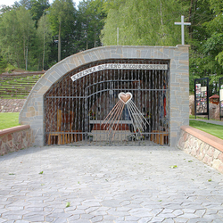 A wrought iron grille on a chapel of Gods mercy with stainless steel and copper wrought heart