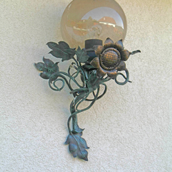 A wrought iron sunflower as a side lamp