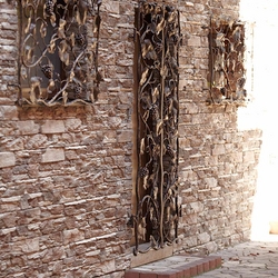 A wrought iron grille in a wine cellar