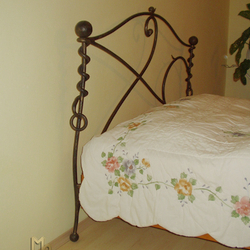 A wrought iron bed headboard