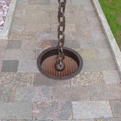 A wrought iron chain gutter