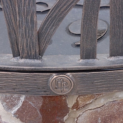 A wrought-iron dome on the well – detail of the UKOVMI logo