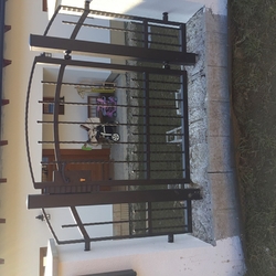 Forged gate as part of the family house fencing