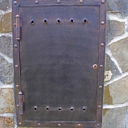 A wrought iron gas metre door