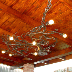 A ceiling wrought iron light in a garden summer house