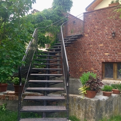 Exterior staircase with railing as a loft apartment entrance