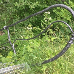 A staircase with a hand-forged railing by the river 