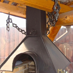 A wrought iron fireplace set