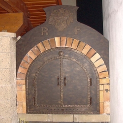A wrought iron door for a pizza oven