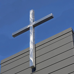 A stainless steel cross on a modern church