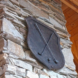 A wrought iron coat of arms - a golf motif