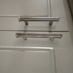 Designer handles for kitchen units, treated with polish and varnish on the surface
