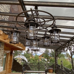 Hand forged chandelier for a cottage patio – an original outdoor lighting