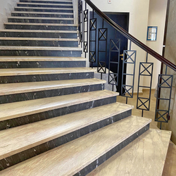 Metal spiral railing with wooden handrail on the staircase of the Tatra hotel