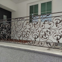 Forged exterior railing at a family home entrance