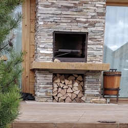 Forged fireplace accessories + a wooden basket with forged accessories on the outside